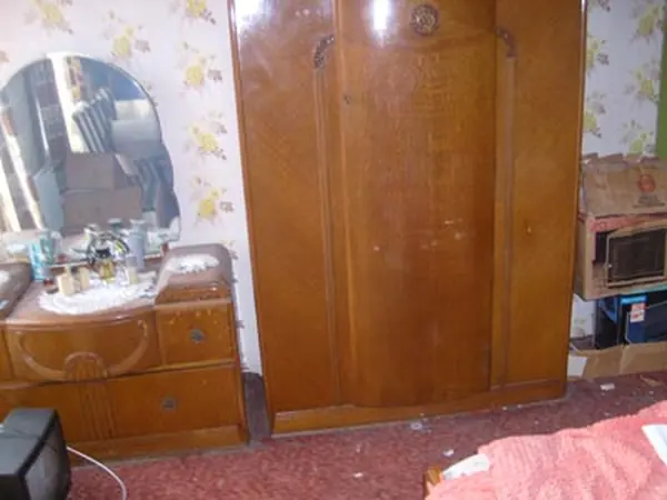 Room filled with bagged rubbish before clearance