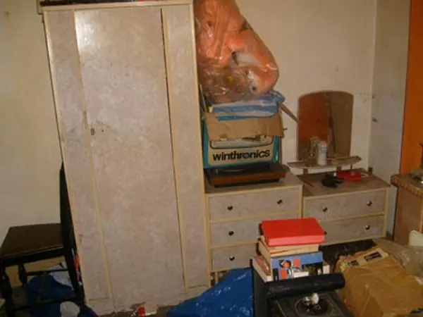 Room filled with bagged rubbish before clearance