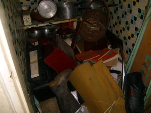 Room filled with bagged rubbish before clearance