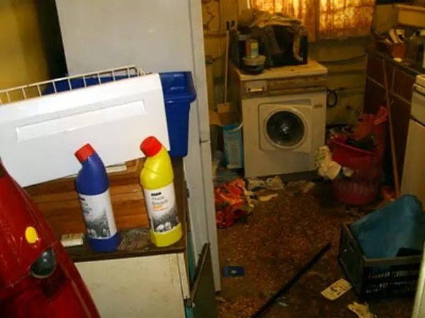 Room filled with bagged rubbish before clearance