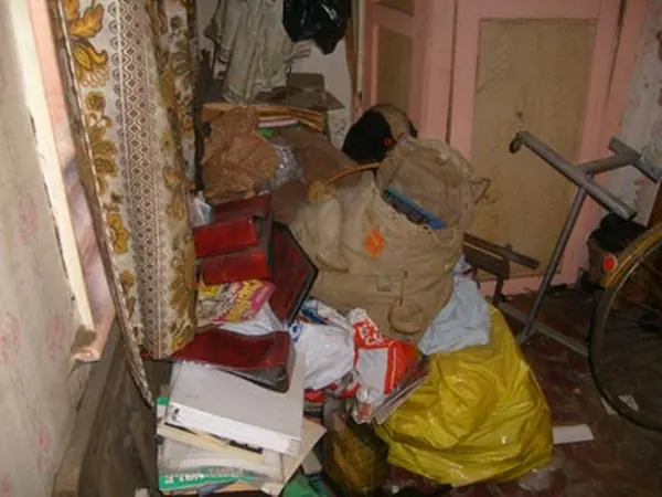 Room filled with bagged rubbish before clearance