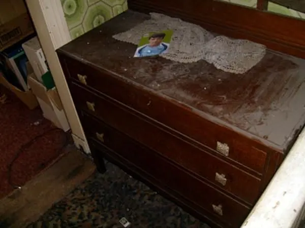 Room filled with bagged rubbish before clearance