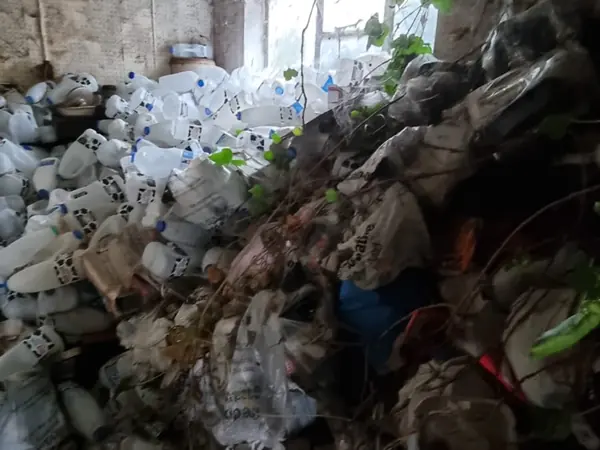 Hallway blocked wall to ceiling with bagged rubbish