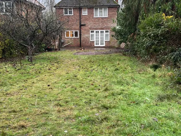 The same garage and garden cleared