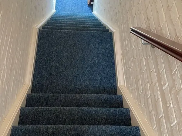 The same rooms emptied and the carpets swept