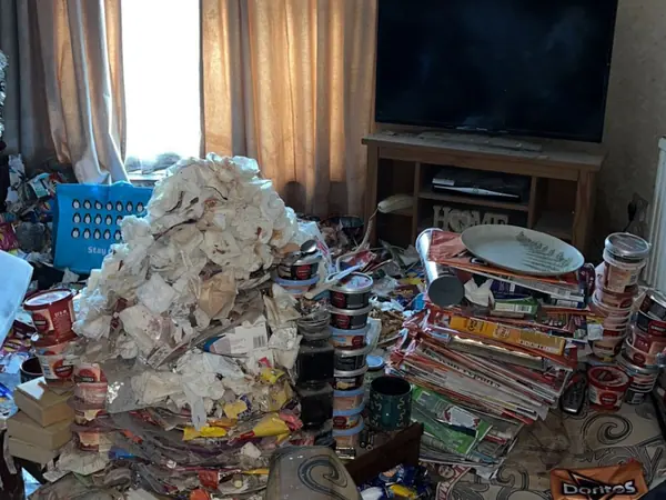 Hoarded kitchen and living rooms before clearance