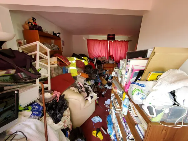 Hoarded kitchen and living rooms before clearance