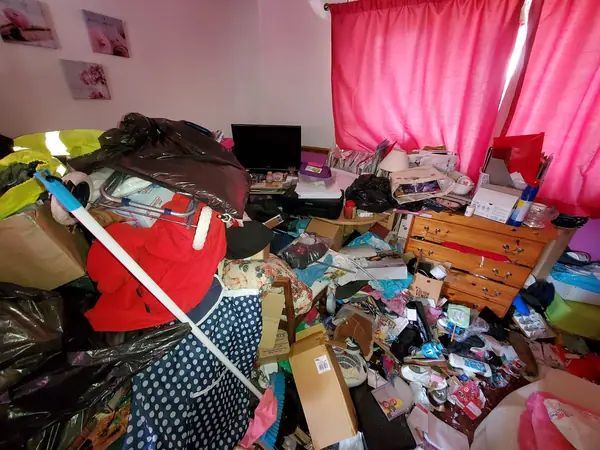 Hoarded kitchen and living rooms before clearance