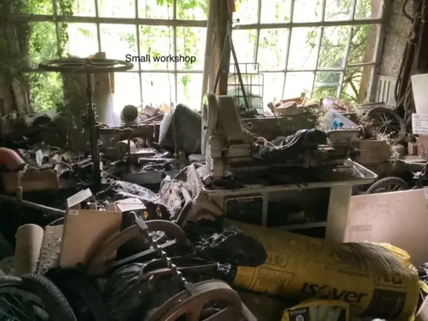 Overgrown yard and workshop before clearance