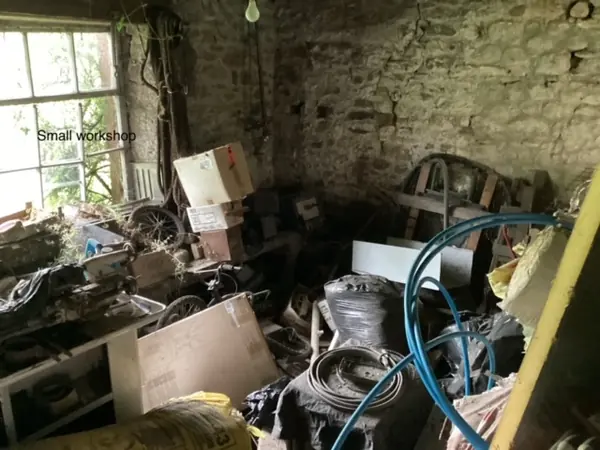 Overgrown yard and workshop before clearance