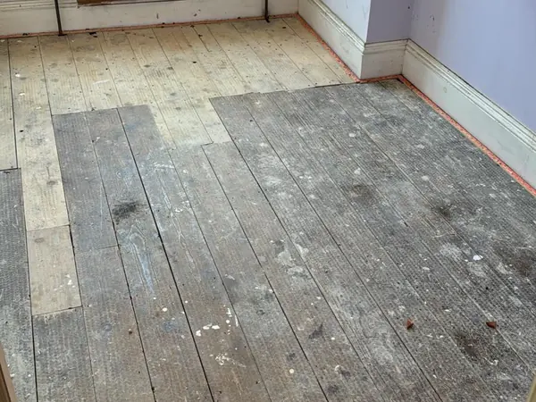 The same rooms emptied, floorboards visible