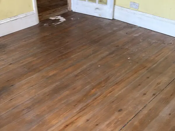 The same rooms emptied, floorboards visible