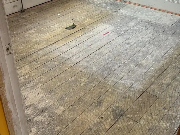 The same rooms emptied, floorboards visible