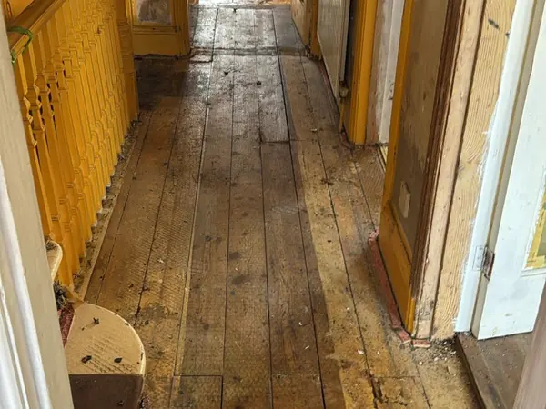 The same rooms emptied, floorboards visible