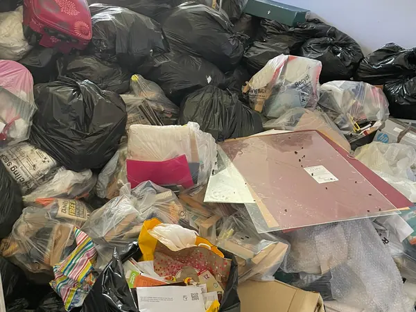 Cottage packed with bags and boxes before clearance